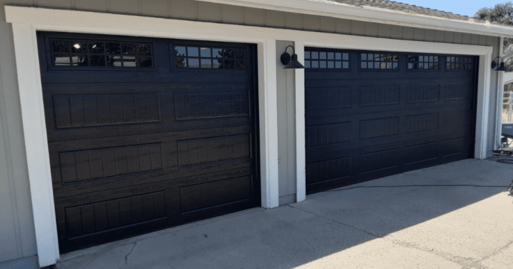 Double black garage doors with window panels