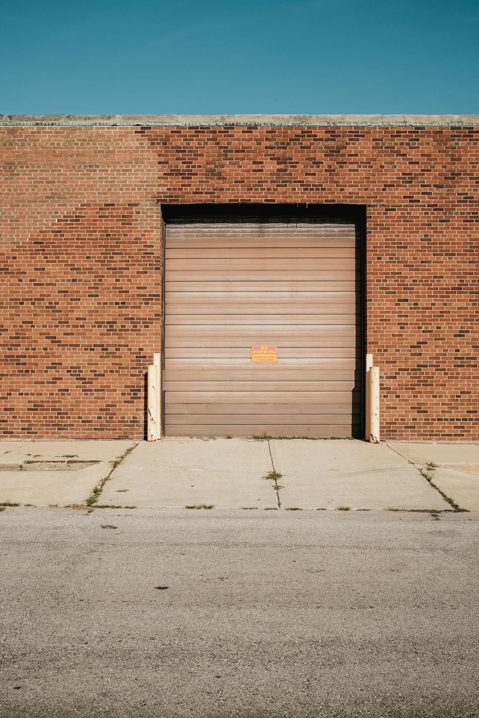 Brick commercial building with a roll-up overhead door